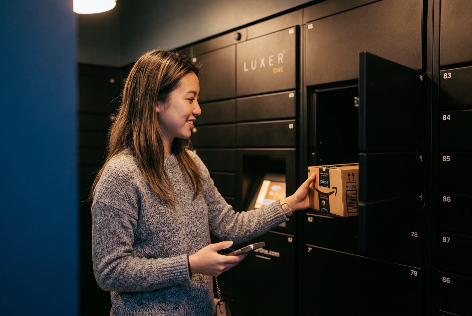 Resident retrieving a package from a locker system